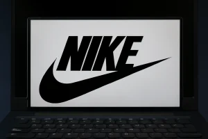 Laptop screen displaying the Nike logo with swoosh in high resolution, representing Nike stock and branding visuals.